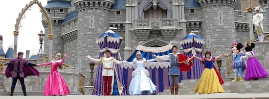 disney princes and princesses on stage with mickey and minnie mouse.