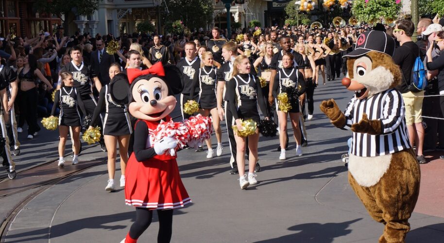 Minnie Mouse and cheerleaders in the UCF parade at Magic Kingdom