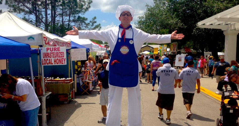 stilt character baker at pie festival in Celebration