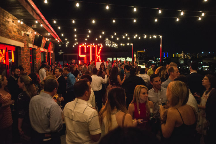Guests enjoying the Florida evening on the patio at STK Orlando's grand opening party