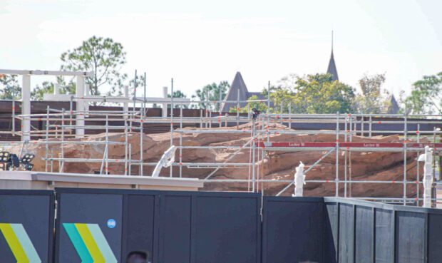 Largest section of Journey of Water rock work seen behind construction walls at Epcot.