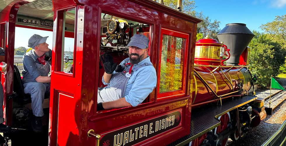Conductor leans out of recently reopened Walt Disney World Railroad steam engine.