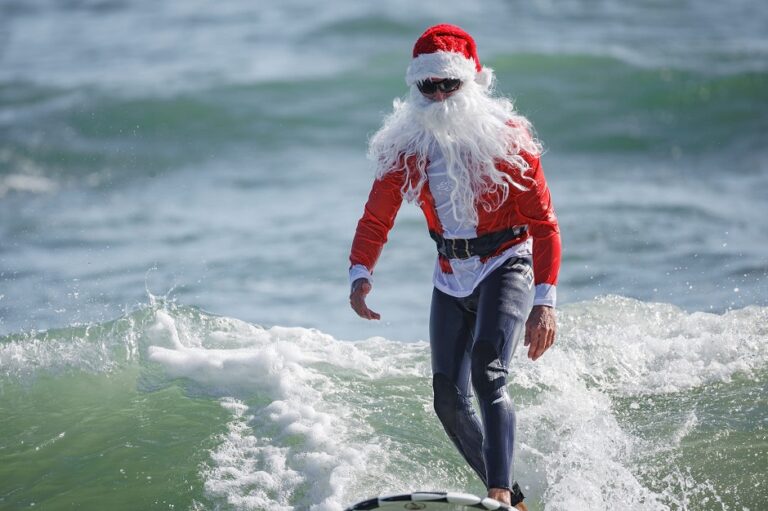 Santa swaps his sleigh for a surfboard on Florida’s Space Coast