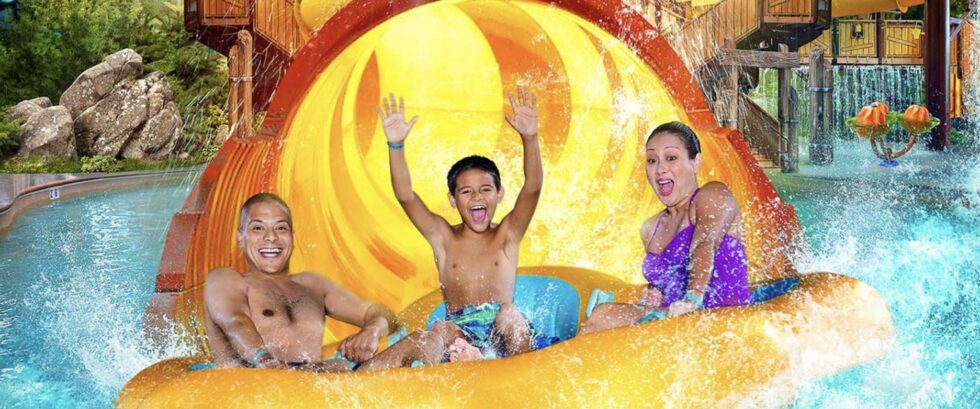 family of three splashes down in water slide at Great Wolf Lodge Maryland