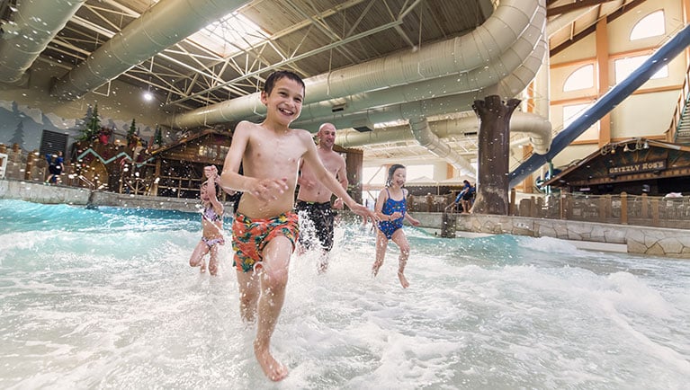 family in wave pool of indoor great wolf lodge