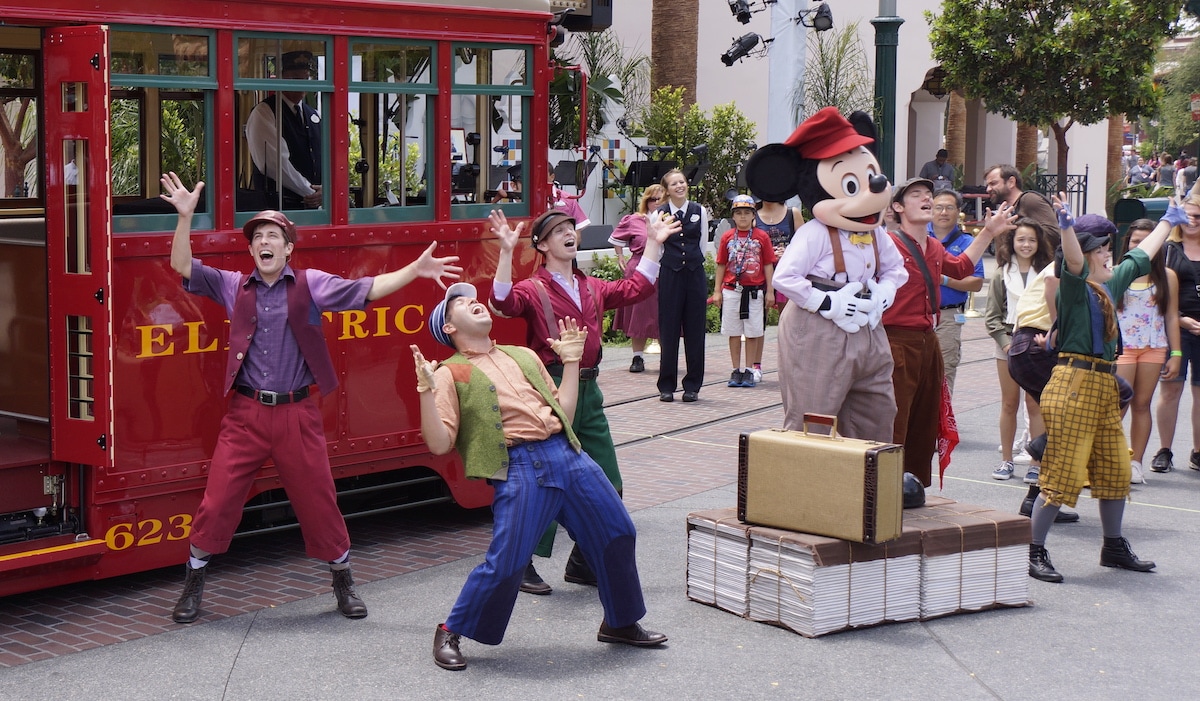 The Red Car Trolley News Boys performing with Mickey Mouse in 2018.
