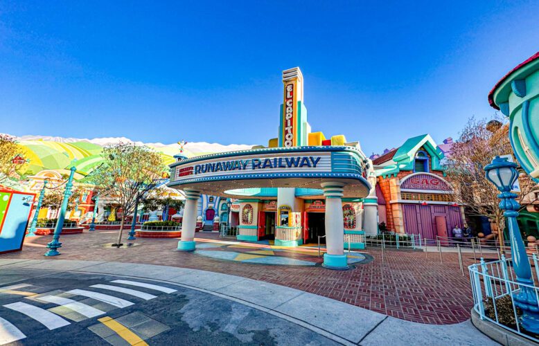 Mickey and Minnie's Runaway Railway in Disneyland is cartoon-ized, unlike the more realistic Grauman's Chinese Theater at Disney's Hollywood Studios.