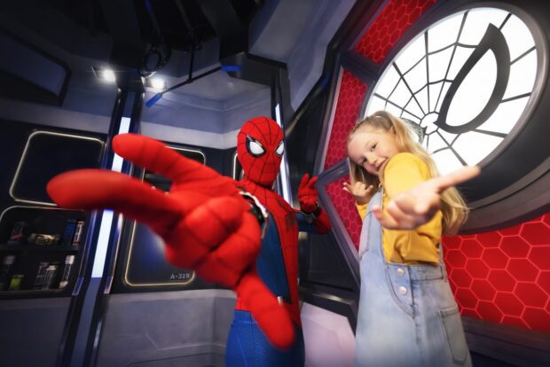 Girl posing heroically with Spider-Man