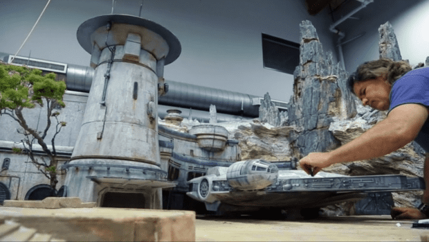 Imagineer puts finishing touches on a model of the Millennium Falcon spaceship