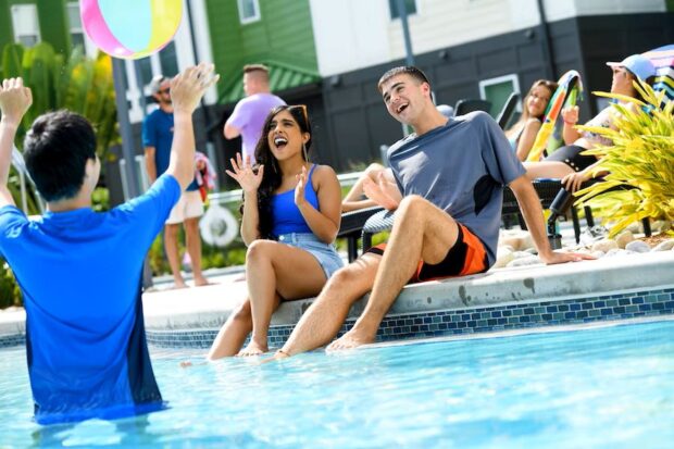 Disney College Program students play in the pool at Flamingo Crossings.
