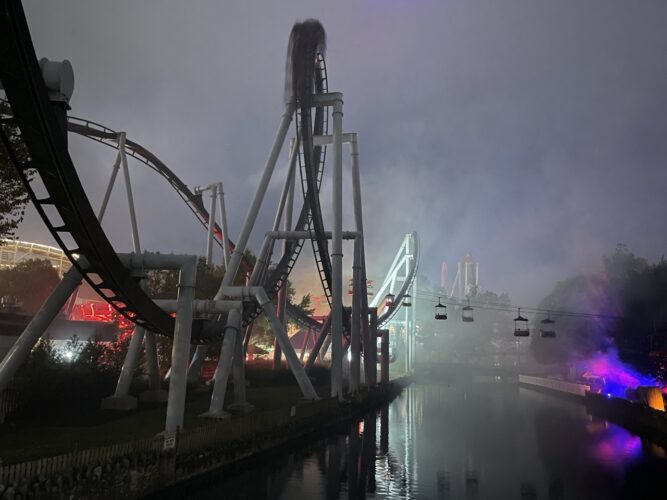 Fog over the water next to a roller coaster at Hersheypark.