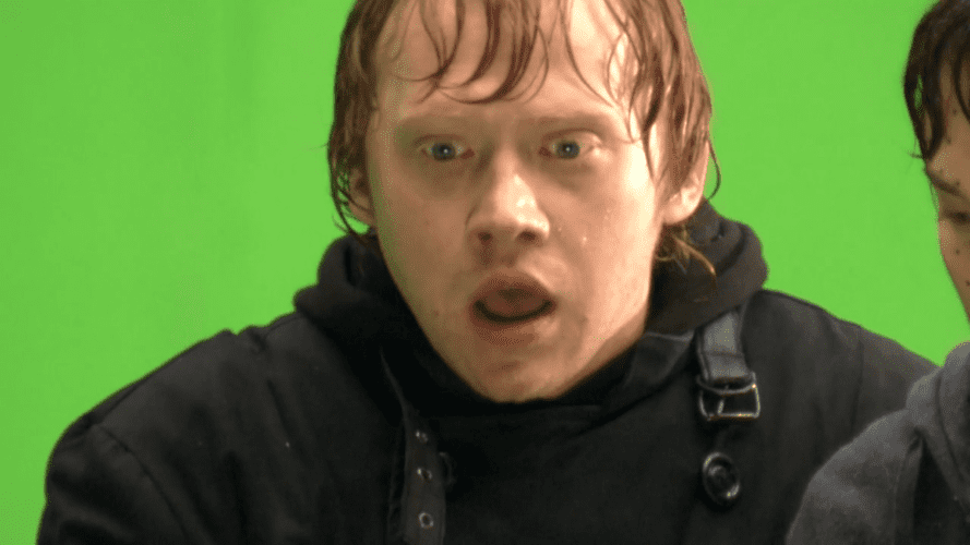 rupert grint in front of a green screen filming for a ride attractions