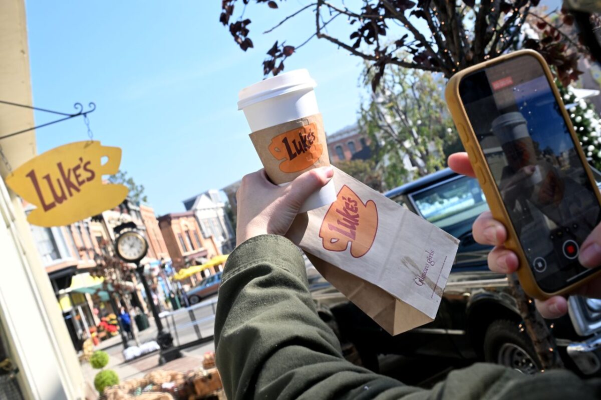 Luke's coffee held in front of a cell phone