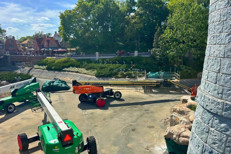 Cinderella Castle paint scheme complete April 2026 machines in empty moat 