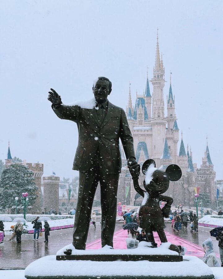 Tokyo Disneyland covered in snow with partners statue