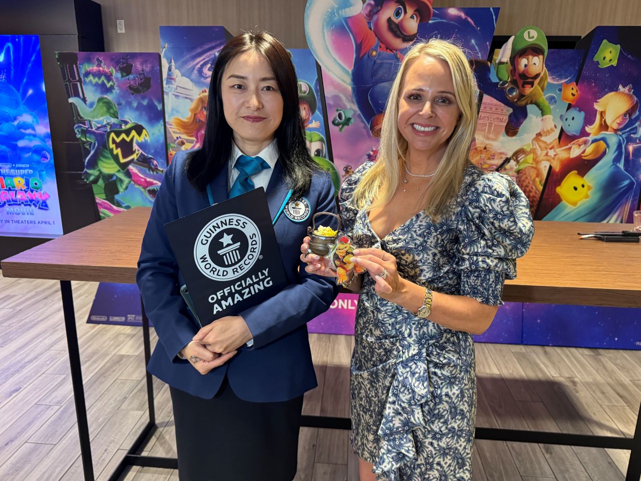 Guinness World Record representatives stand with small Bowsers Couldron popcorn bucket