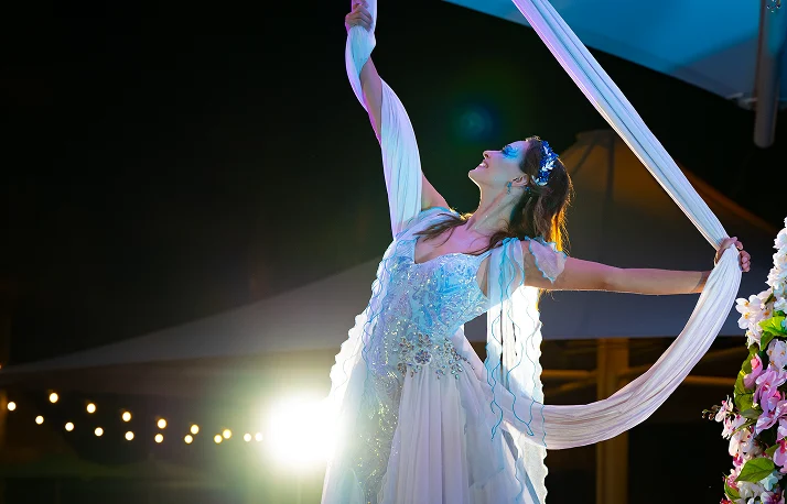 Discovery Cove Paradise Nights live show performer in white gown