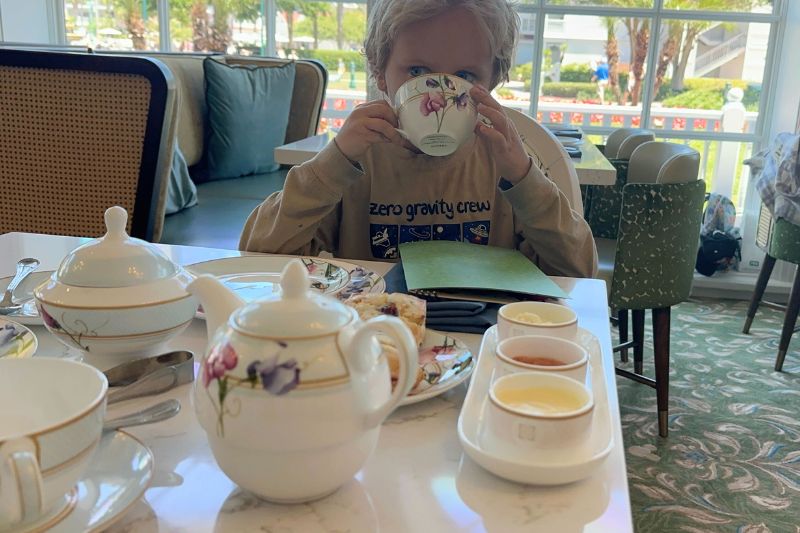 Grand Floridian afternoon tea young boy sipping from teacup