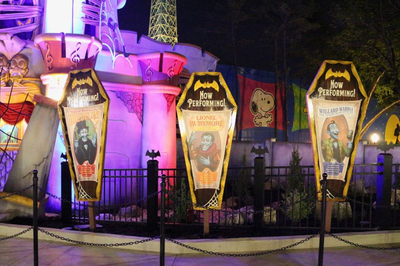 Phantom Theater Opening Nightmare entrance at night, character posters.

