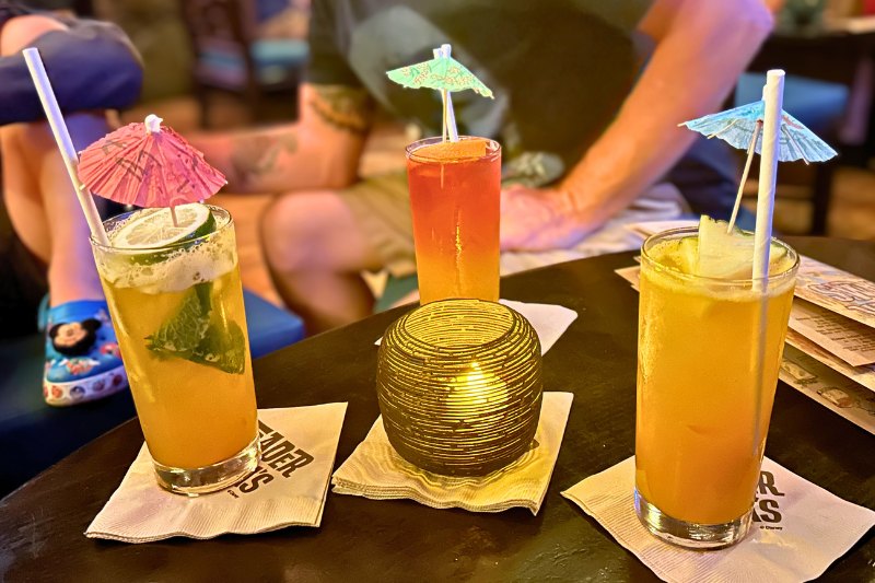 Trader Sam's Grog Grotto No-Booze Brews three drinks on a table