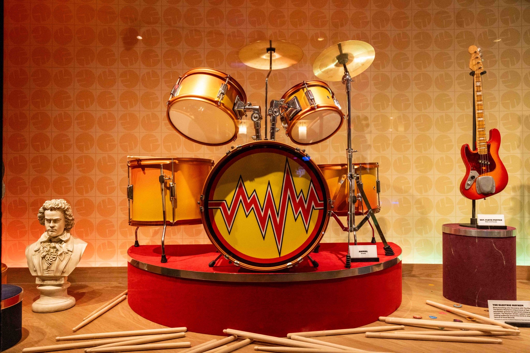 drum set and guitar from the electric mayhem muppets in a display case