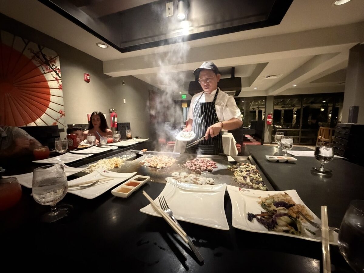 A Teppanyaki chef prepares resort guest meals tableside. 