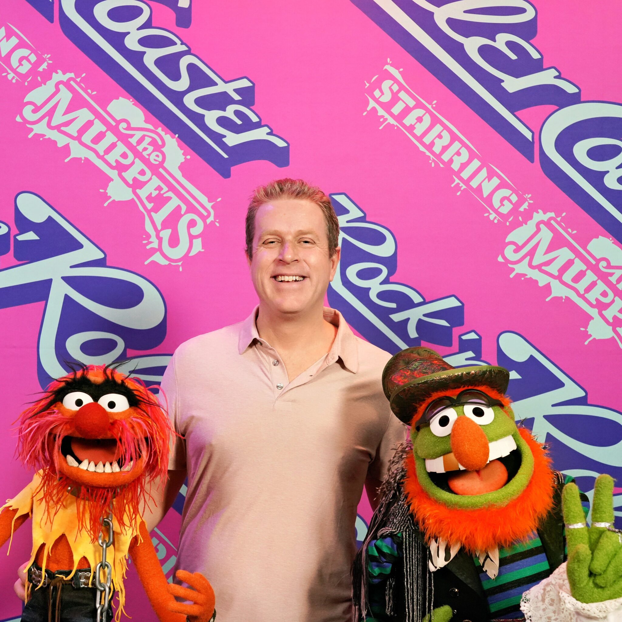 Geoff Keighley poses with animal and dr. teeth muppets