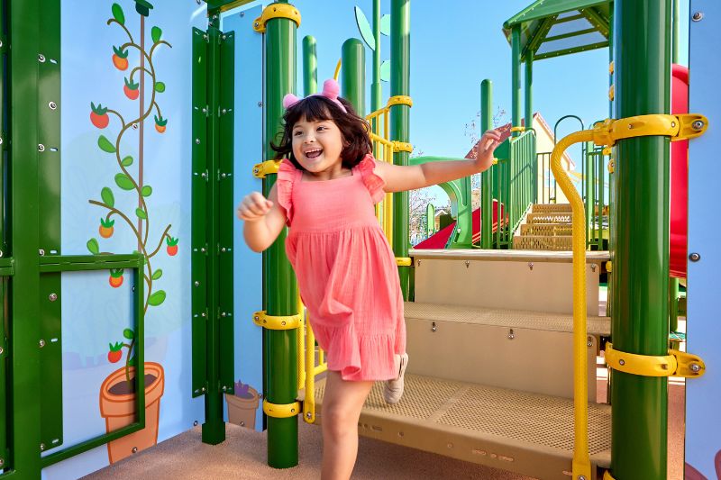 young girl on playground Grandpa Pig's Greenhouse_Peppa Pig Theme Park