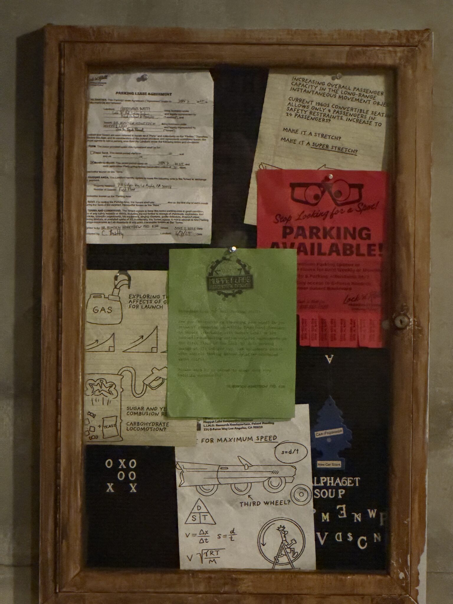 bulletin board of flyers with muppets themes