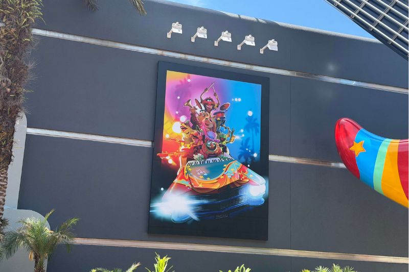 Rock n Roller Coaster starring The Muppets completed poster on gray building -