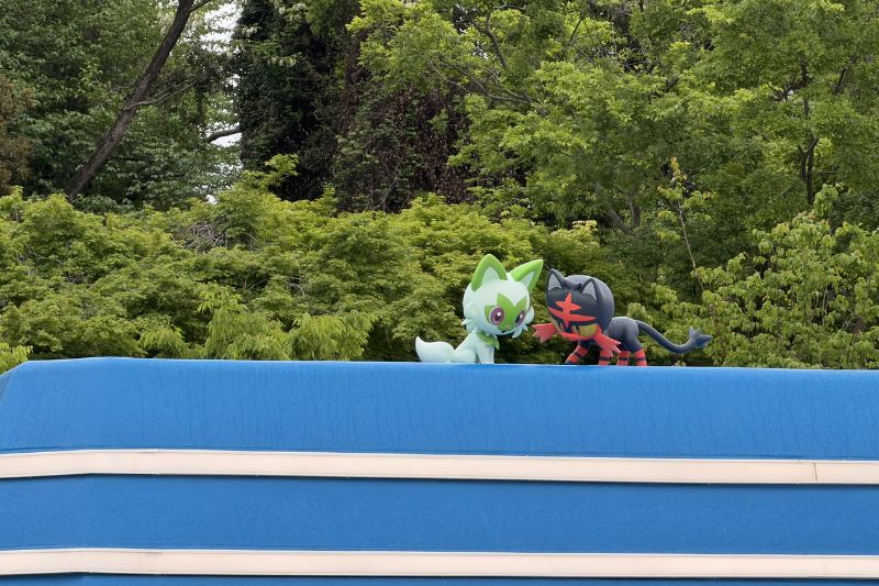 Sprigatito and Torracat figures on roof in Sedge Town at PokéPark Kanto