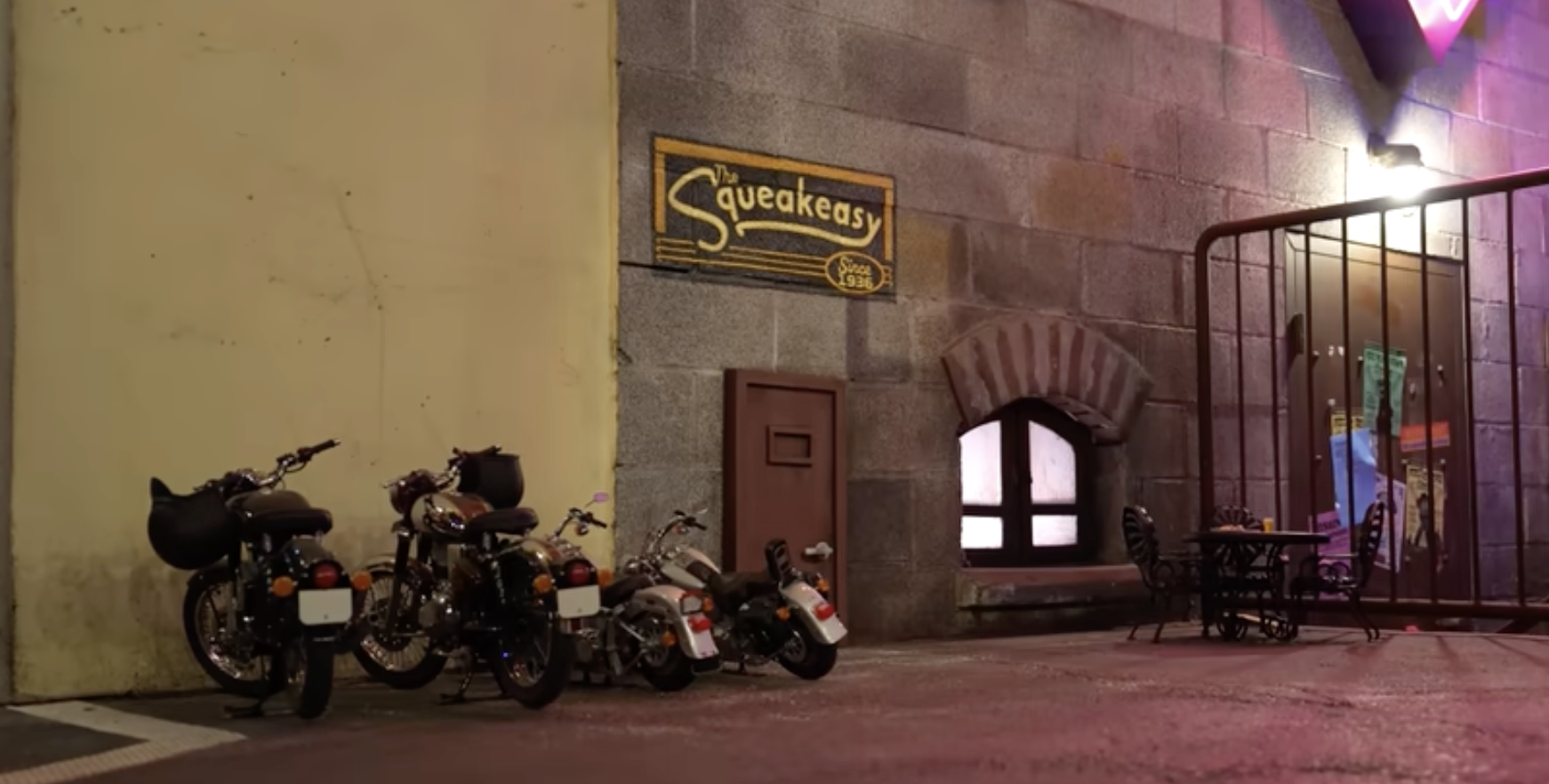 screen capture showing small motorcycles at entrance of the squeakeasy a club for mice