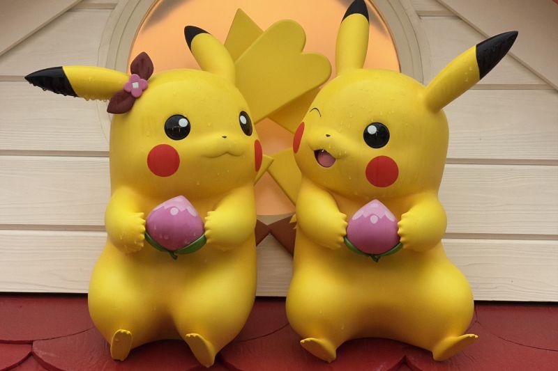 male and female Pikachu figures on roof in Sedge Town at PokéPark Kanto - Photo by Mai