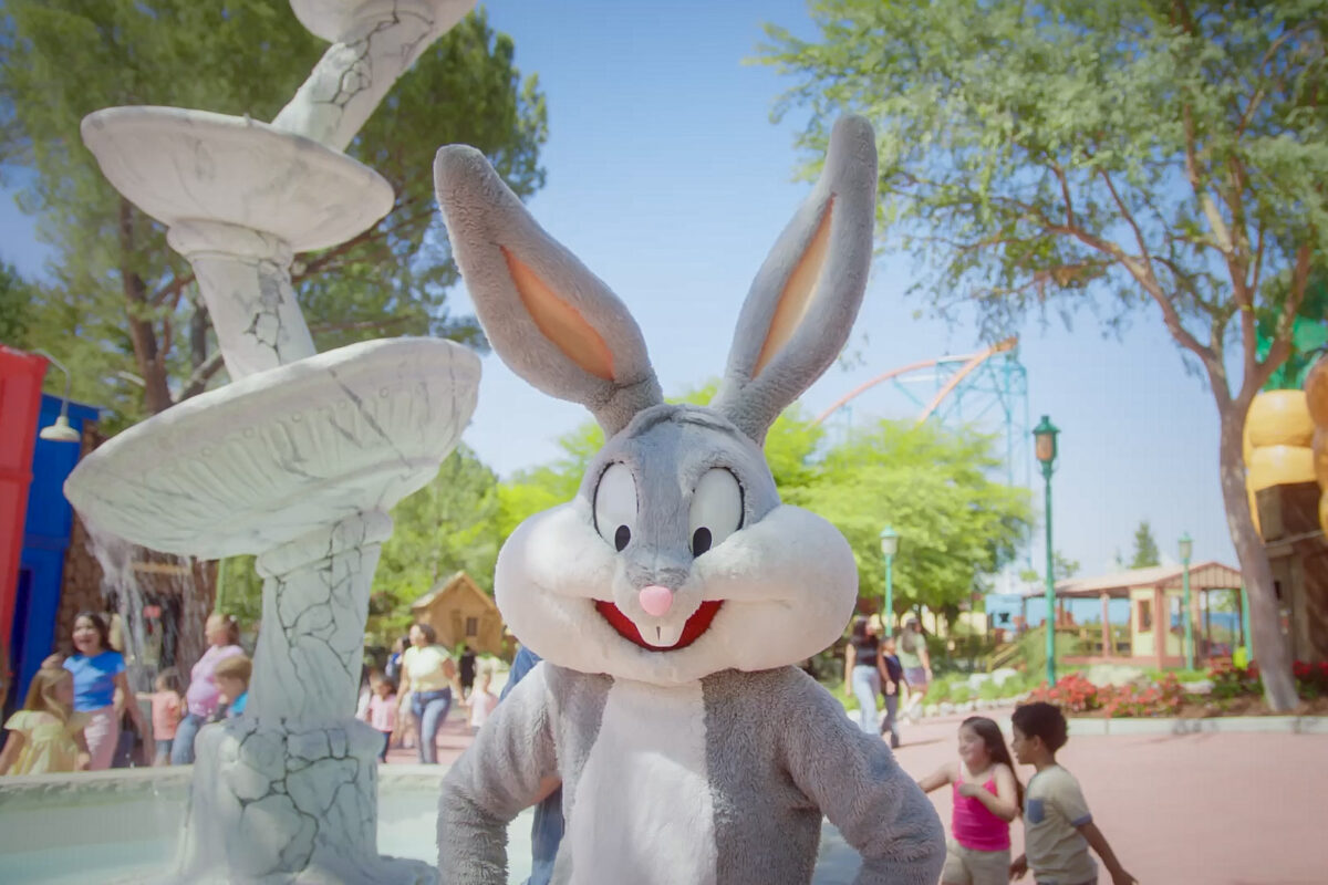 Bugs Bunny standing in front of a fountain at Looney Tunes Land