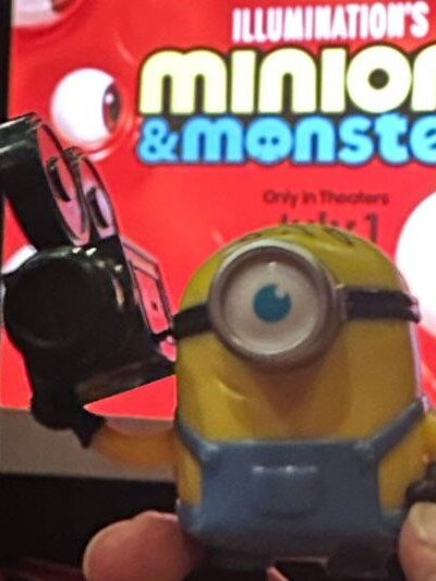 Wendy's James toy in front of Minions & Monsters screen 