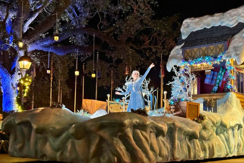 elsa character on disney parade float for christmas party