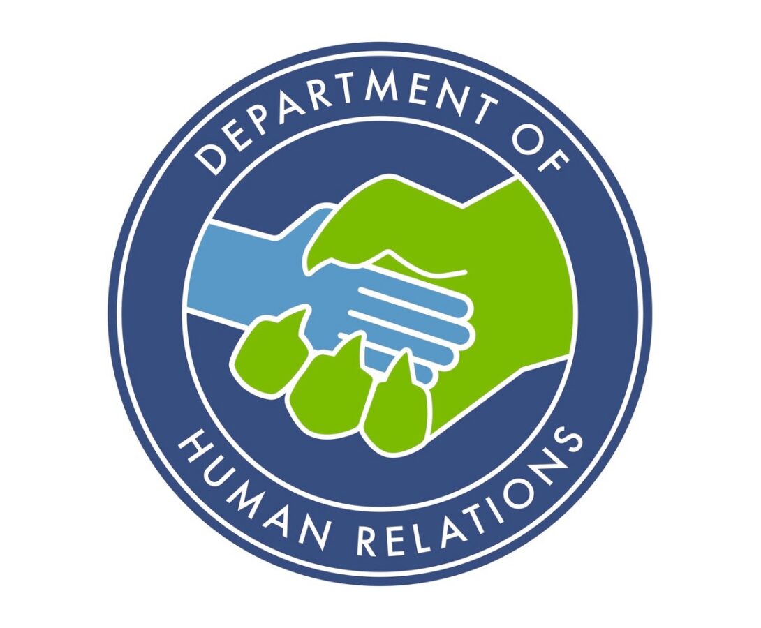 Monsters Inc Human Relations logo with monster hand shaking a human hand