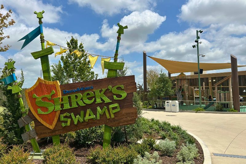 Shrek's Swamp sign at Universal Kids Resort playground in the background