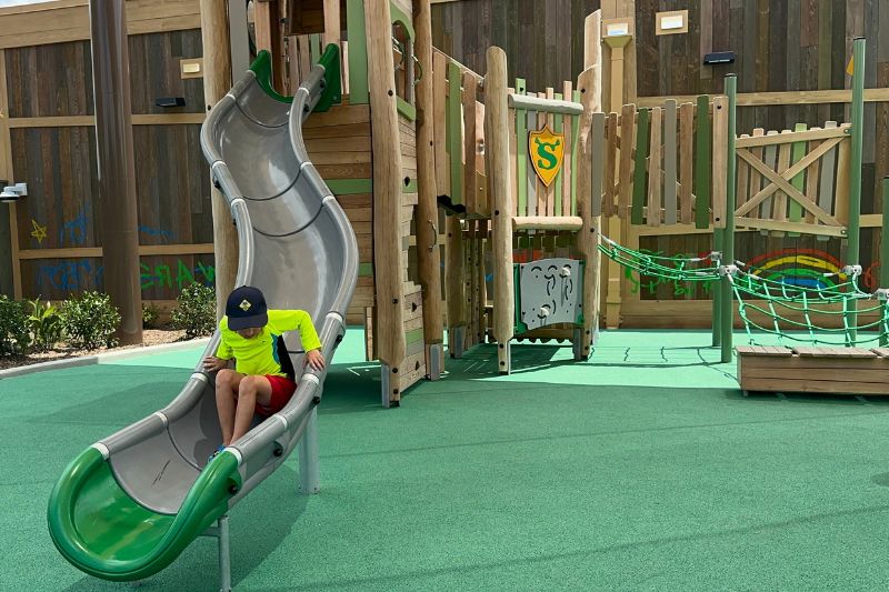 young boy on slide of shrek playgorund
