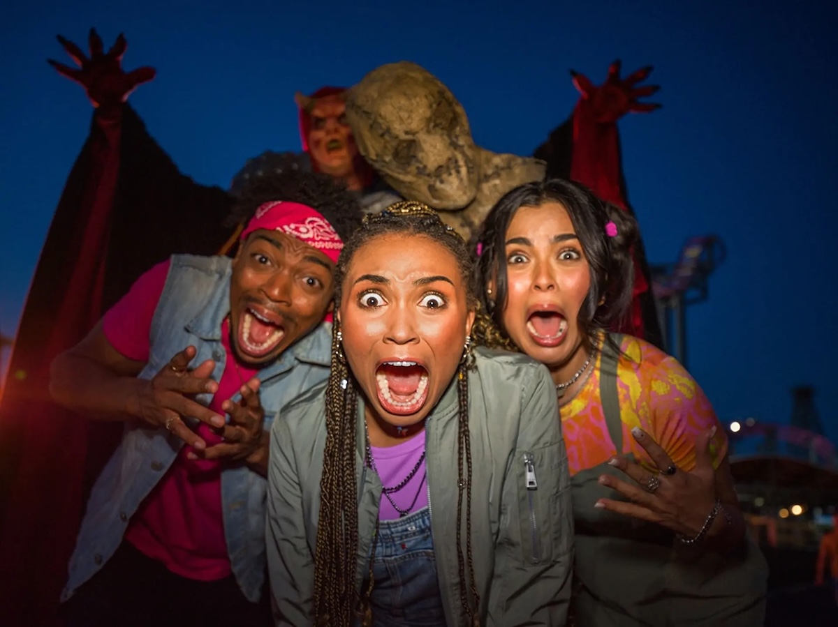 marketing photo of scared guests with six flags fright fest performers behind them