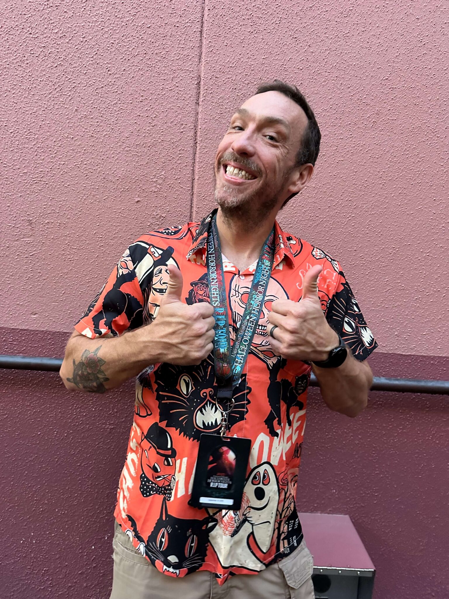 Man smiling with a R.I.P. Tour lanyard Halloween Horror Nights