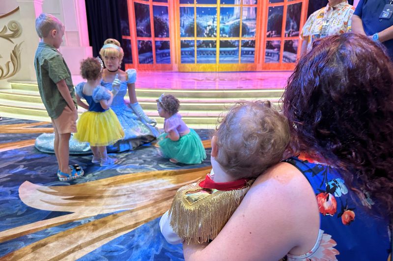Toddler boy as Prince Charming while twin girls in princess costumes meet Cinderella Disney Cruise Line Royal Gathering