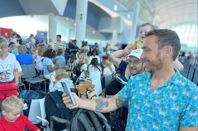 Waiting in Disney Cruise Line terminal using cell phone for video call
