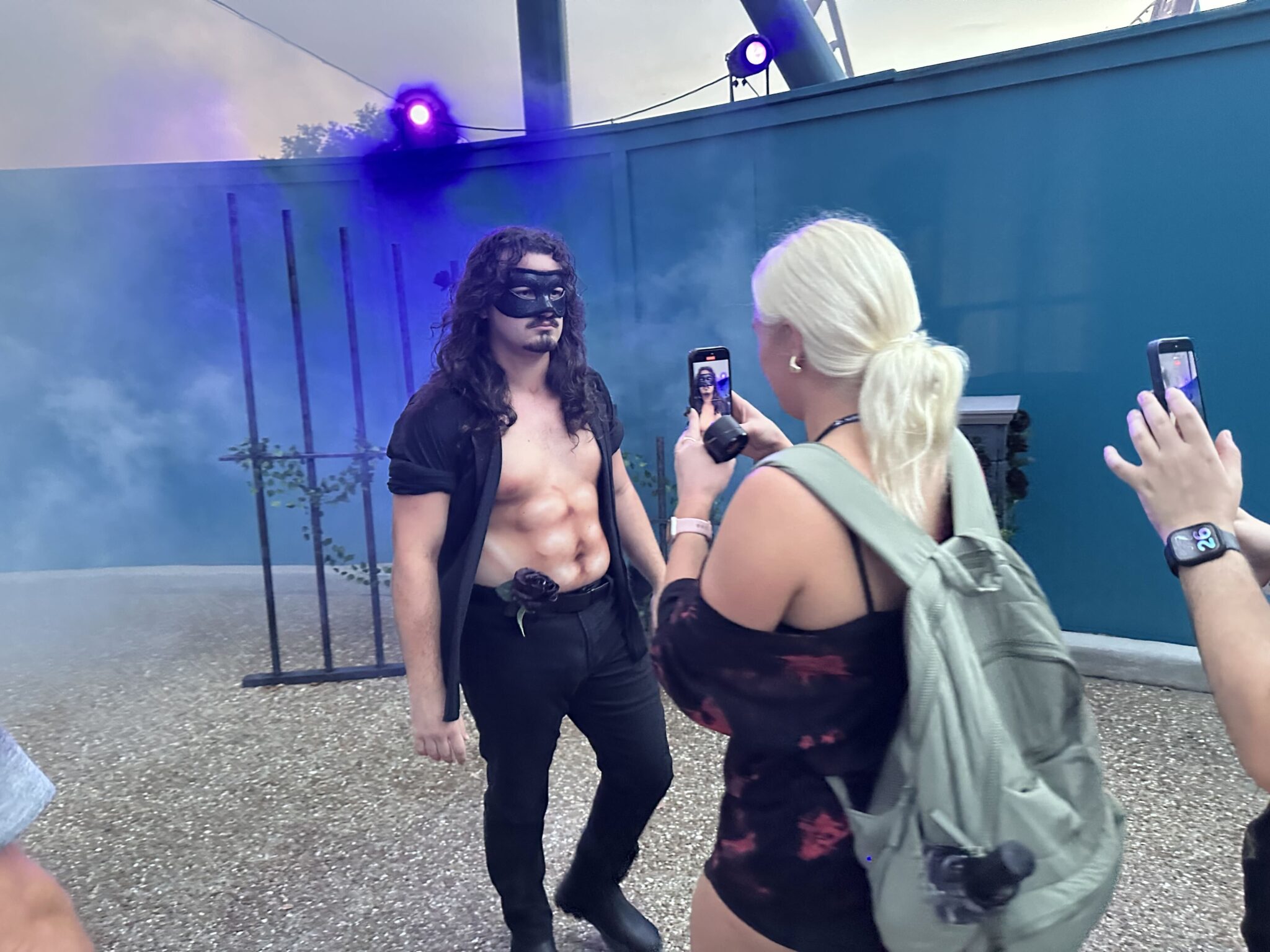 masked man with airbrush abs interacts with media at One More Chapter Dark Romance scare zone Howl o Scream Orlando 