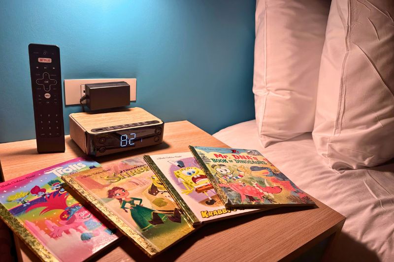 Bedside table with bluetooth alarm clock and sound machine at Universal Kids Resort Hotel