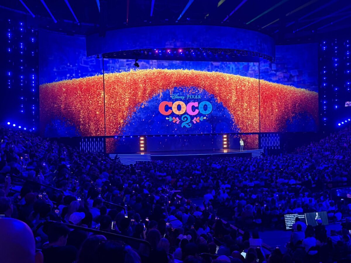 coco 2 graphic on screen on stage at D23 presentation