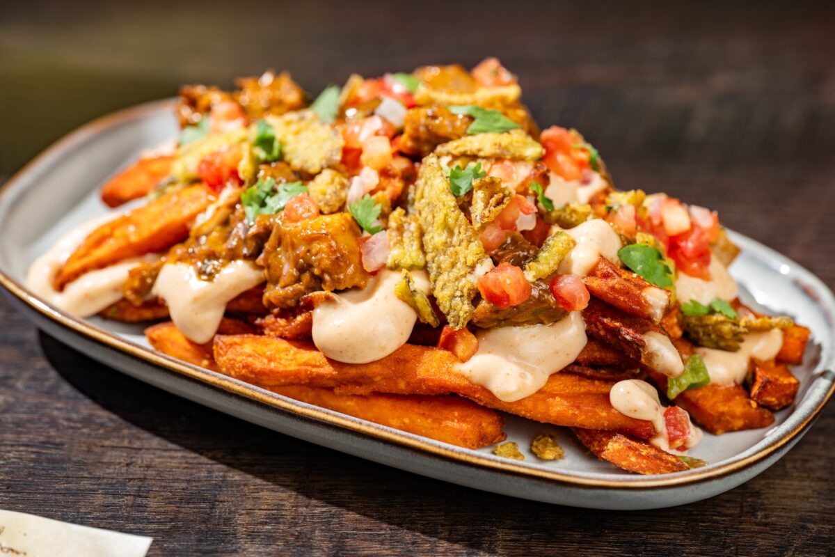 promotional photo of sweet potato fries with layers of toppings