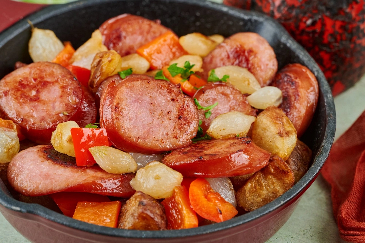 sausage and vegetables on a cast iron pan