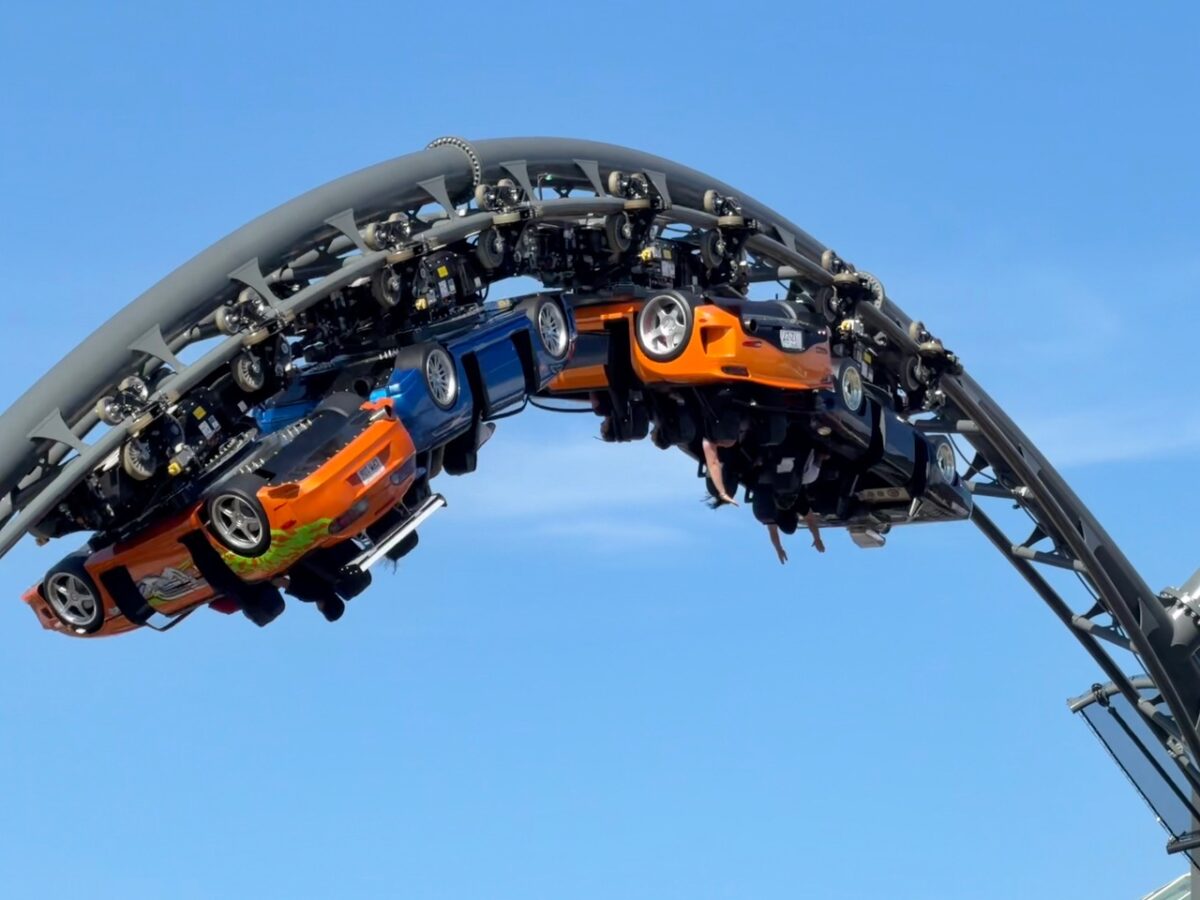 Fast & Furious Hollywood Drift coaster inversion guests with hands in the air