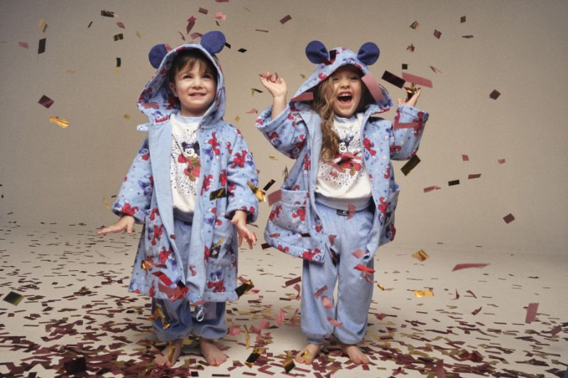two kid models pose with confetti for Macy's x Disney Kids merchandise 